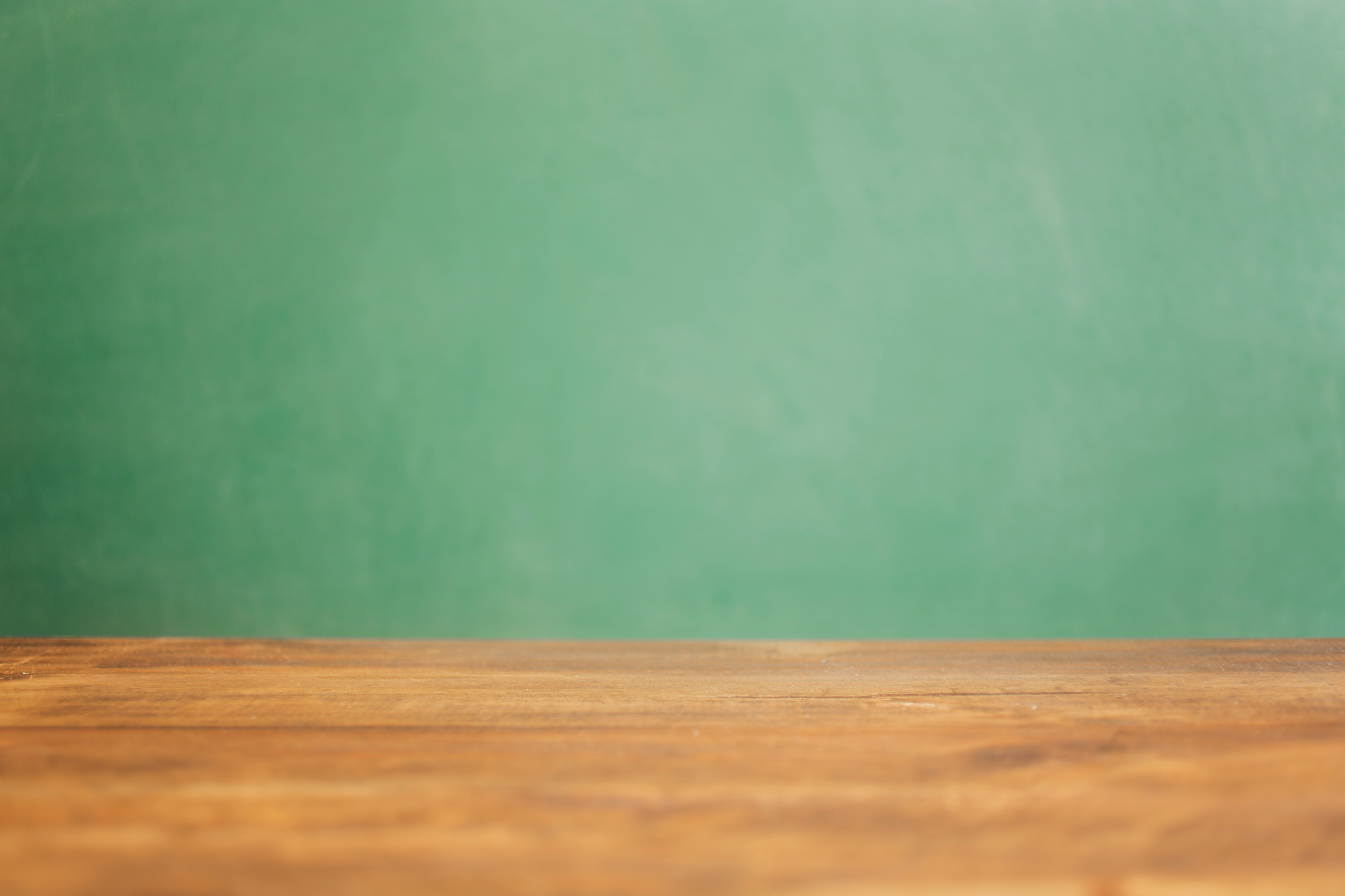 Back to school, educational background. Desk with green chalkboard.